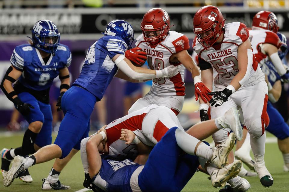 West Sioux quarterback Dylan Wiggins (10) is stopped by Van Meter linebacker John Braun (34) during the Class 1A state championship game