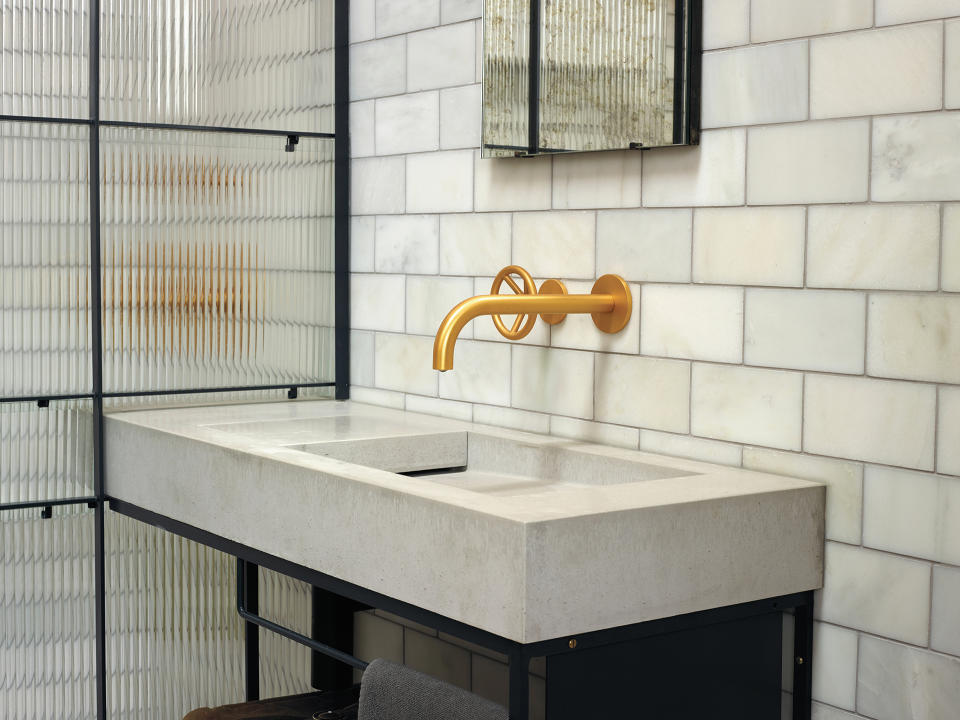 concrete basin and countertop in bathroom with white metro tiles on wall