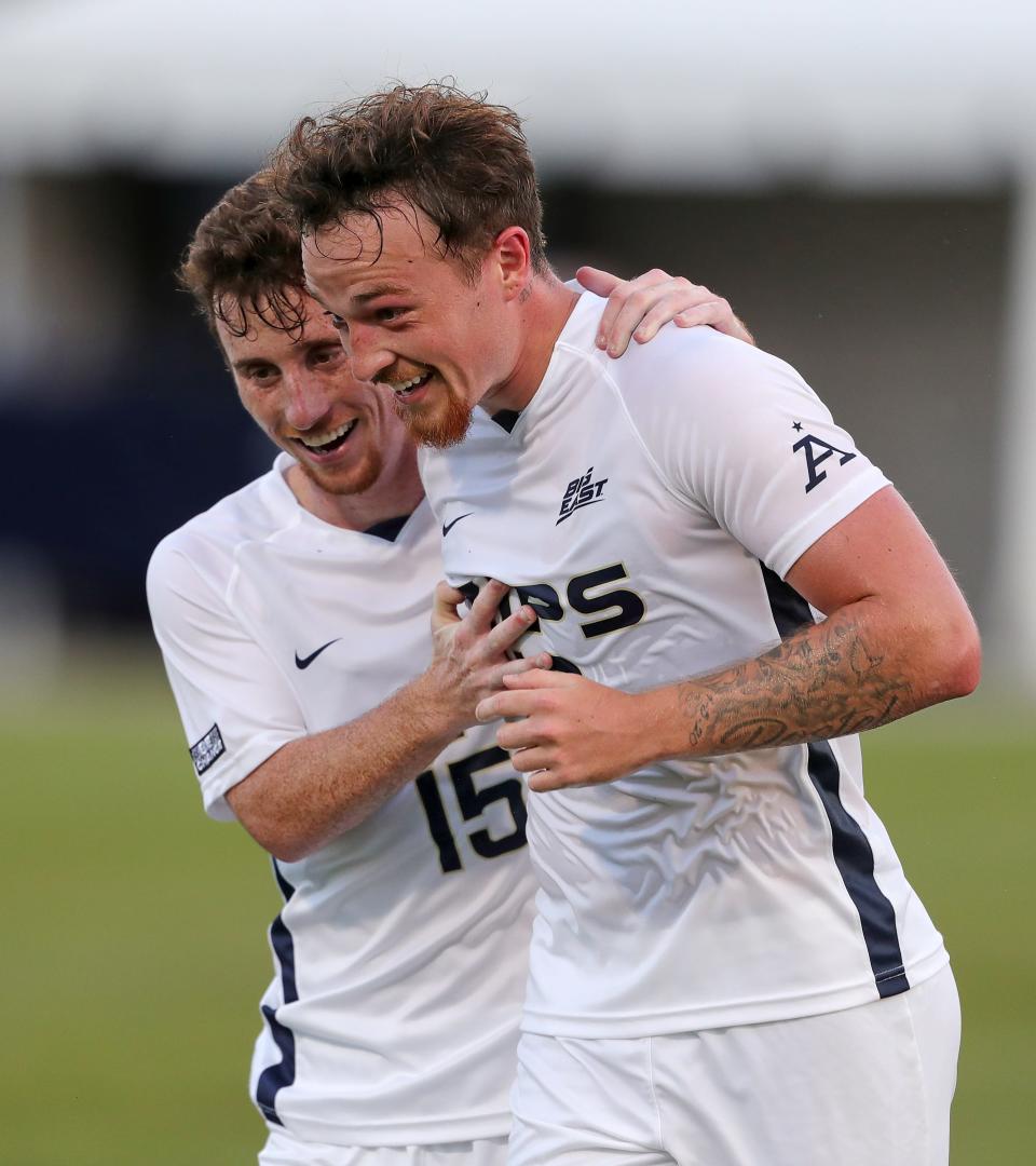 Akron midfielder Dyson Clapier, right, is congratulated by teammate Johnny Fitzgerald after scoring a goal during the first half against Niagara Thursday in Akron.