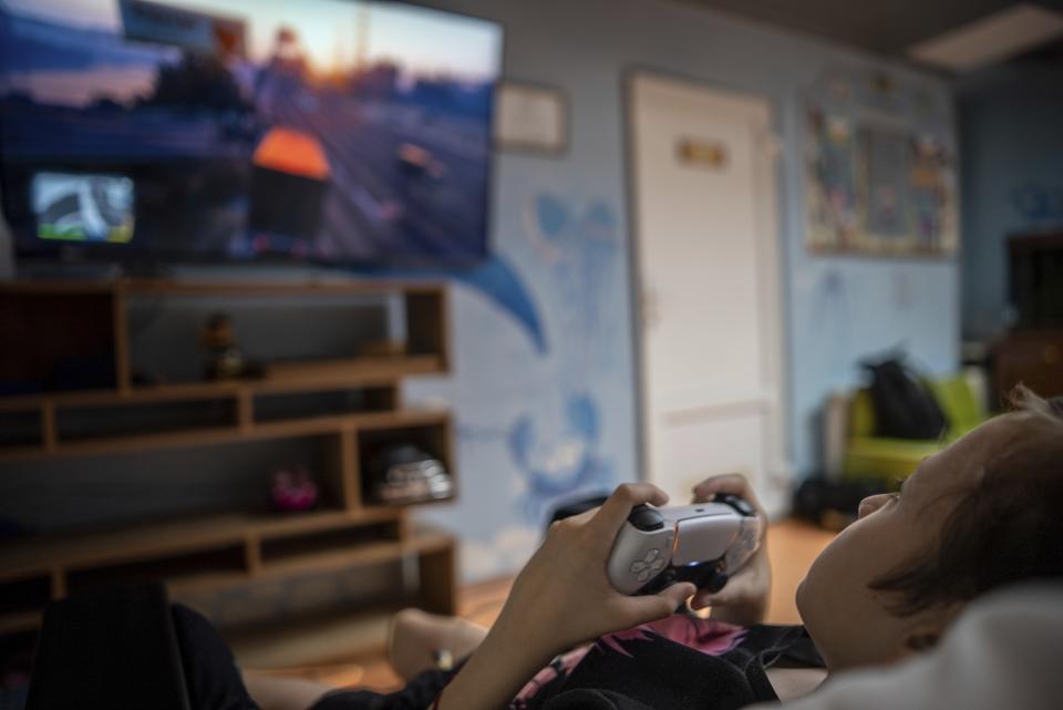 Denys Vasylenko, 11, plays on a video game console at the National Cancer Institute in Kyiv, Ukraine, Wednesday, July 10, 2024. Denys is one of 31 young patients battling cancer who were relocated to the hospital from Okhmatdyt Children’s Hospital after it was struck by a Russian missile this week. (AP Photo/Alex Babenko)