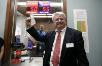 Attorney Joe Day holds up the winning $241 million Powerball ticket before it is cashed in for his clients, a group of workers from the Quaker Oats plant in Cedar Rapids, Iowa, at the Iowa Lottery headquarters, Wednesday, June 20, 2012, in Des Moines, Iowa. Lottery spokeswoman Mary Neubauer says one of the workers bought the winning ticket for the group for the June 13 drawing and the winnings will be split 20 ways.(AP Photo/Charlie Neibergall)