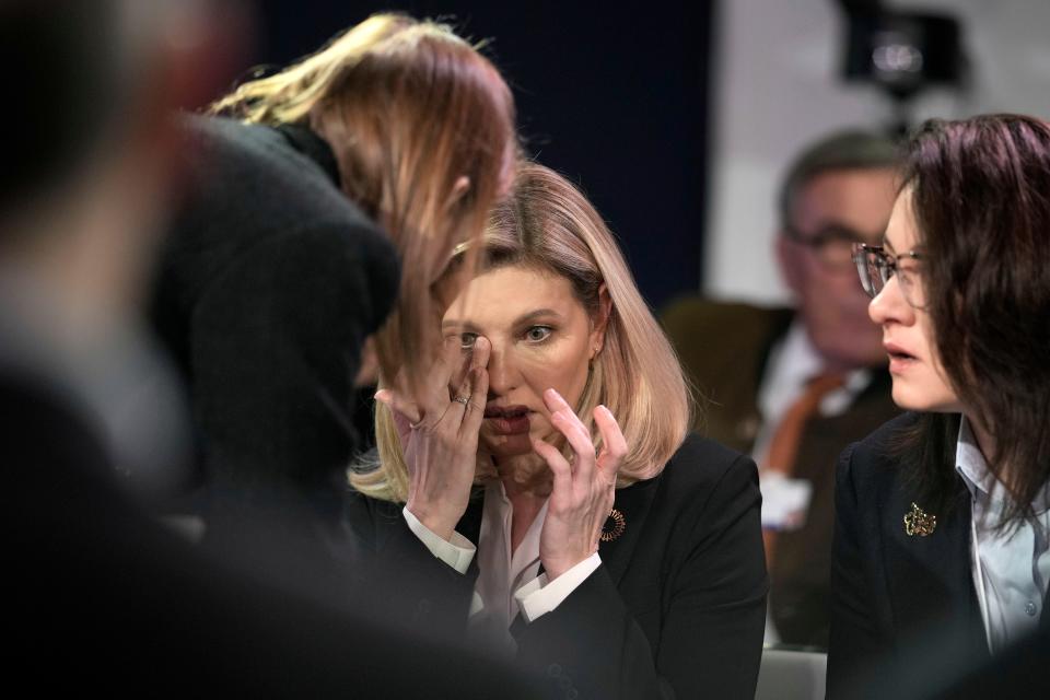 First Lady of Ukraine Olena Zelenska, center, reacts beside First Vice Prime Minister of Ukraine Yulia Svyrydenko, right, at the World Economic Forum in Davos, Switzerland after a helicopter crash in Ukraine, where Minister of Internal Affairs Denys Monastyrsky died among others on Wednesday, Jan. 18, 2023.