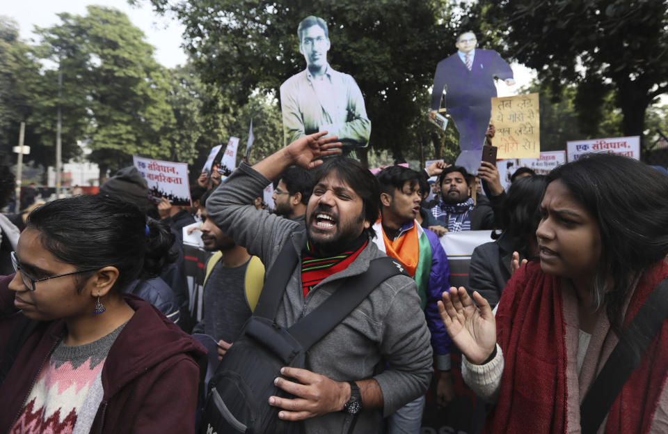 Students shout slogans against government during a protest against new citizenship law in New Delhi, India, Tuesday, Dec. 24, 2019. Hundreds of students marched Tuesday through the streets of New Delhi to Jantar Mantar, an area designated for protests near Parliament, against the new citizenship law, that allows Hindus, Christians and other religious minorities who are in India illegally to become citizens if they can show they were persecuted because of their religion in Muslim-majority Bangladesh, Pakistan and Afghanistan. It does not apply to Muslims. (AP Photo/Manish Swarup)