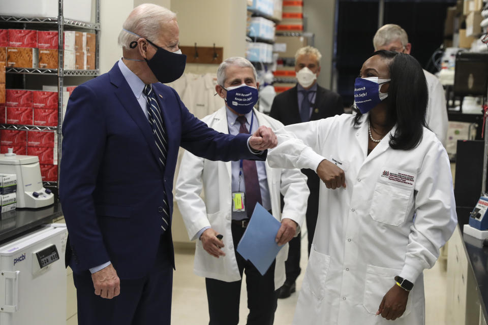 President Biden wears a protective mask while greeting Kizzmekia Corbett, an immunologist with the vaccine research center at the National Institutes of Health, during a tour in Bethesda, Maryland, on Feb. 11, 2021. / Credit: Oliver Contreras/Sipa/Bloomberg via Getty Images