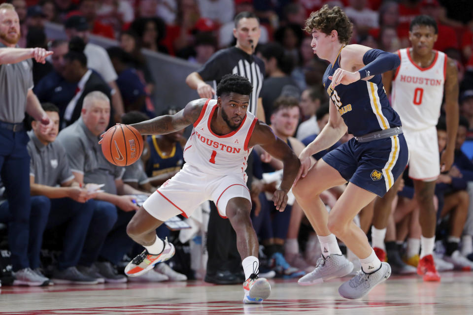 Houston guard Jamal Shead (1) looks to drive around Northern Colorado guard Caleb Shaw, right, during the first half of an NCAA college basketball game Monday, Nov. 7, 2022, in Houston. (AP Photo/Michael Wyke)