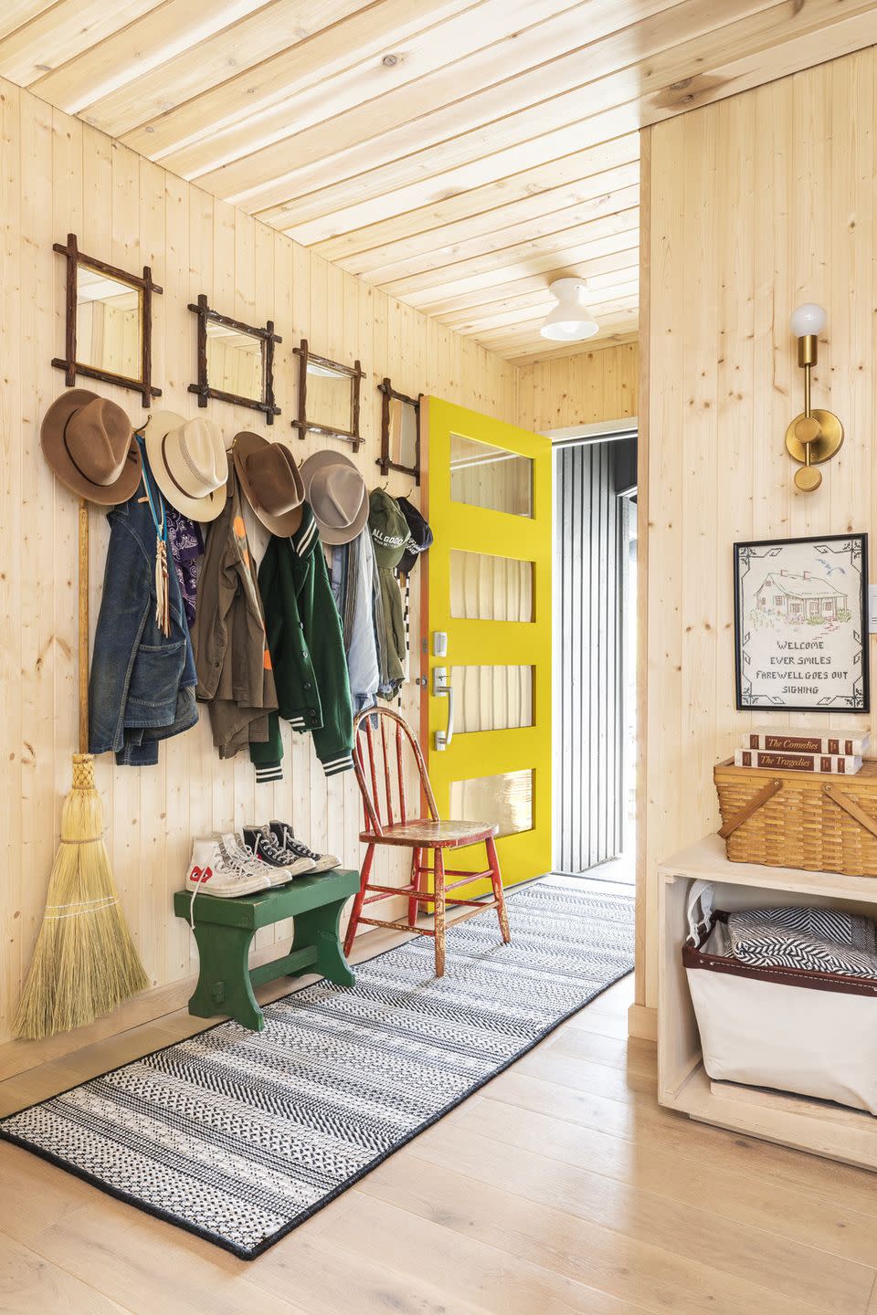 pine paneled entryway with yellow front door