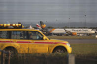 A Thomas Cook plane on the tarmac at Gatwick Airport in Sussex, England Monday Sept. 23, 2019. British tour company Thomas Cook collapsed early Monday after failing to secure emergency funding, leaving tens of thousands of vacationers stranded abroad. (Steve Parsons/PA via AP)