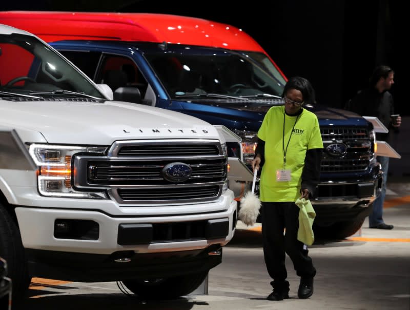 FILE PHOTO: FILE PHOTO: A worker cleans Ford pickup truck at the North American International Auto Show in Detroit, Michigan
