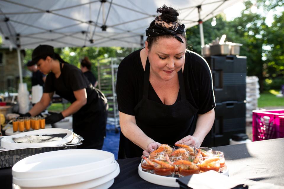 Chef Kate Williams prepares appetizers for guests during MOCAD's Summer Arts Soirée at the Charles T. Fisher Mansion in Detroit on Thursday, July 13, 2023.