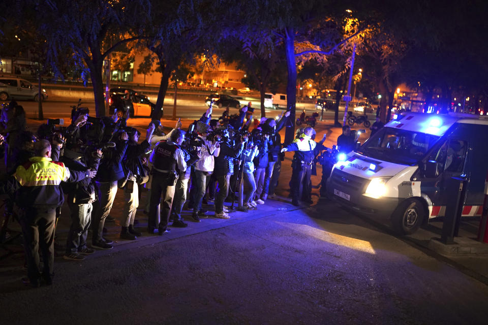 Reporters take pictures of a police van, allegedly carrying soccer player Dani Alves, outside the Barcelona courthouse, Spain, Friday, Jan. 20, 2023. Brazilian soccer player Dani Alves has been arrested after being accused of sexually assaulting a woman in Barcelona. Police say the alleged act took place on Dec. 31 at a night club in Barcelona. (AP Photo/Joan Mateu Parra)