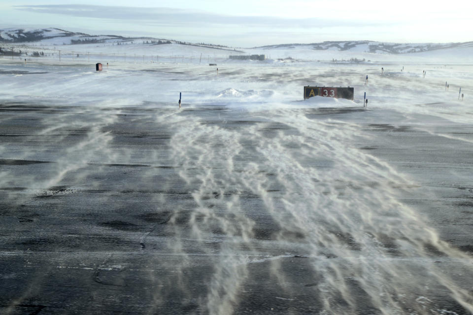 In this Feb. 15, 2019, photo, winds carry snow across the tarmac of the Unalakleet Airport in Alaska. The airport is a common stop between Nome and villages to the south. (AP Photo/Wong Maye-E)