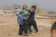 In this Thursday, Feb. 13, 2020 photo, Afghan refugee boys fight in a refugee camp, in the Kabobayan refugee camp, Peshawar, Pakistan. After 40 years, more than 1.5 million Afghan refugees still live in neighboring Pakistan. They feel abandoned by their own government, increasingly unwelcome in their reluctant host country and ignored by the United Nations. (AP Photo/Muhammad Sajjad)