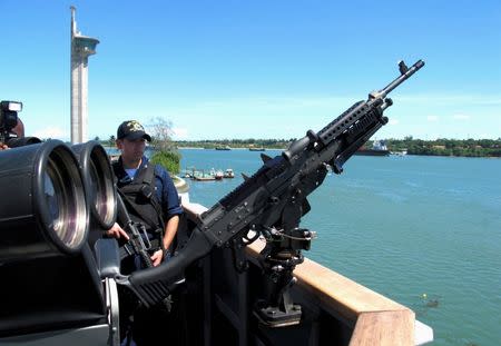 A machine gun is mounted on U.S. Destroyer USS Momsen (DDG92) as it docks in the Indian Ocean in Mombasa, May 7, 2008. REUTERS/Joseph Okanga/File Photo