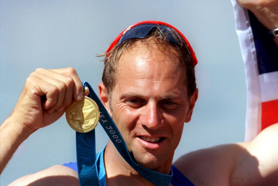 Great Britain's Steve Redgrave celebrates with his gold medal, the 5th he has won in his career
