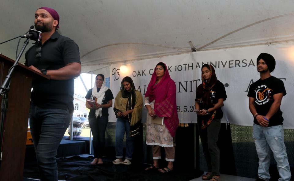 Kamal Saini, son of Paramjit Kaur Saini, who was among the victims killed in the Aug. 5, 2012, mass shooting at the Sikh Temple of Wisconsin, talks about the loss of his mother while speaking during the Oak Creek Sikh Memorial Anniversary Candlelight Remembrance Vigil on Friday in Oak Creek. Also joining him are others who also lost loved ones on the day of the mass shooting and who shared their personal stories as well.