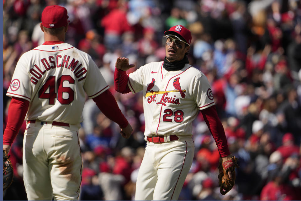 St. Louis Cardinals' Nolan Arenado (28) and Paul Goldschmidt (46) celebrate a 4-1 victory over the Toronto Blue Jays in a baseball game Saturday, April 1, 2023, in St. Louis. (AP Photo/Jeff Roberson)