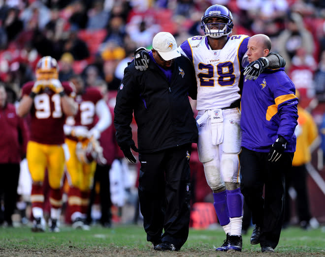 LANDOVER, MD - DECEMBER 24: Running back Adrian Peterson #28 of the Minnesota Vikings is helped off the field after being injured in the third quarter against the Washington Redskins at FedEx Field on December 24, 2011 in Landover, Maryland. (Photo by Patrick Smith/Getty Images)