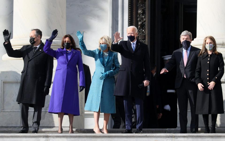 (L-R) Doug Emhoff, U.S. Vice President-elect Kamala Harris, Jill Biden and President-elect Joe Biden wave as they arrive on the East Front of the U.S. Capitol for the inauguration - Joe Raedle /Getty Images North America 