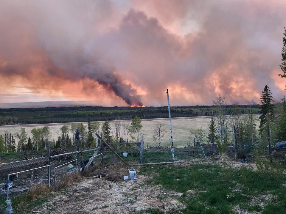 File: Smoke rises after a zombie fire erupts in Western Canada on May 14, 2024. Wildfires in Western Canada prompted thousands to flee their homes, while 66,000 were on standby to evacuate as a fast-moving blaze threatened another community Saturday.