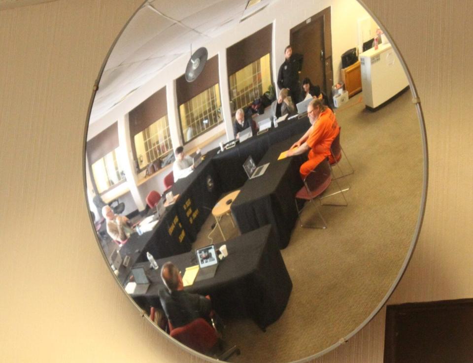 The reflection of Wayne Edmonds Jr. is seen as he prepares to testify before the South Dakota Board of Pardons and Paroles on March 15, 2023, at the Jameson Annex of the South Dakota State Penitentiary.