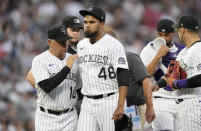 Colorado Rockies manager Bud Black, left, taps starting pitcher German Marquez, who was pulled during the fourth inning of the team' baseball game against the Los Angeles Dodgers on Wednesday, June 29, 2022, in Denver. (AP Photo/David Zalubowski)