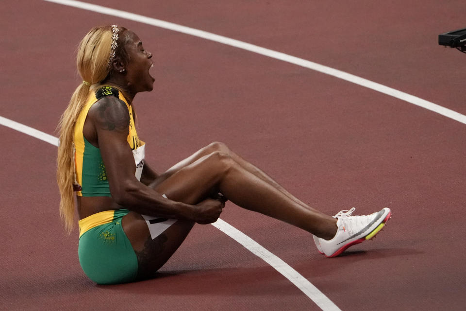 Elaine Thompson-Herah, of Jamaica, celebrates after winning the women's 100-meter final at the 2020 Summer Olympics, Saturday, July 31, 2021, in Tokyo. (AP Photo/Charlie Riedel)