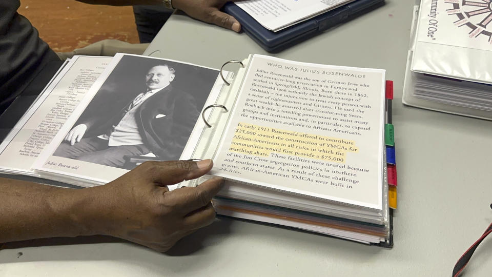 Pastor Charlie Grant shows a binder of information he has about Rosenwald Schools he gathered as he worked to restore a building in Hampton County on Tuesday, July 11, 2023, in Hampton, S.C. Jewish businessman Julius Rosenwald donated money to help build 5,000 schools for Black students across the American South a century ago. Only about 500 are standing and roughly half of them have been restored. (AP Photo/Jeffrey Collins)