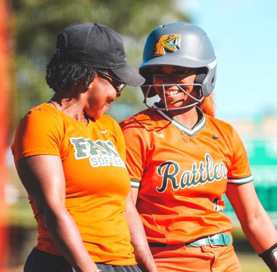 Florida A&M softball head coach Camise Patterson and outfielder Melkayla Irvis shares a laugh during a game against Alabama State at the University Softball Complex in Tallahassee, Florida, Friday, April 14, 2023