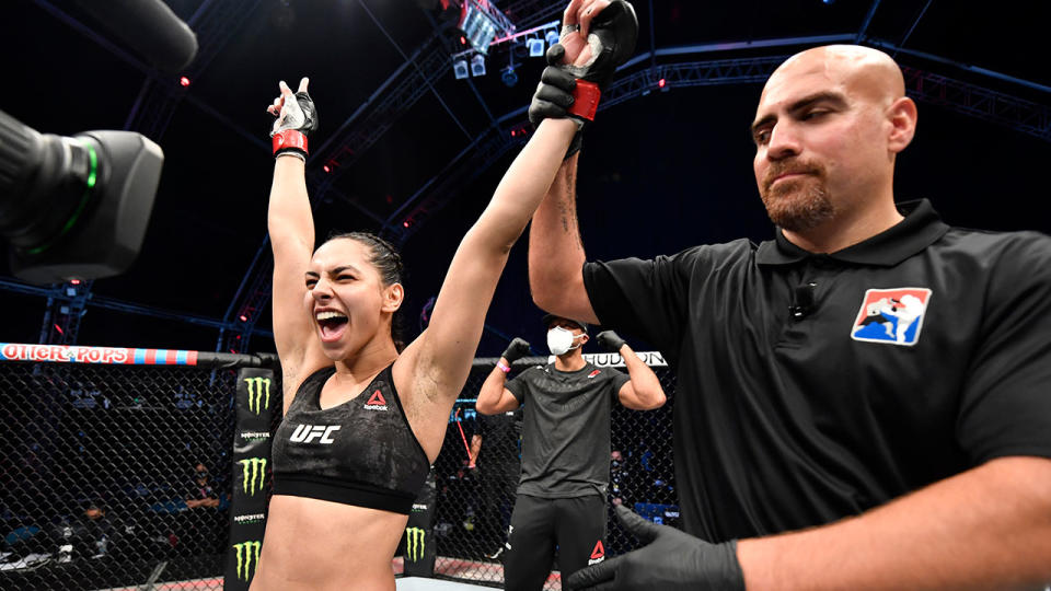 Seen here, Ariane Lipski raises her arms in victory at UFC's Fight Island.