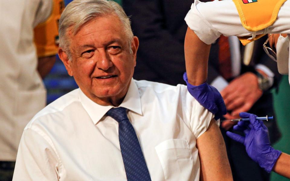 Mexican President Andres Manuel Lopez Obrador gets a shot of the AstraZeneca vaccine for COVID-19 during his daily, morning news conference at the presidential palace  - AP Photo/Fernando Llano