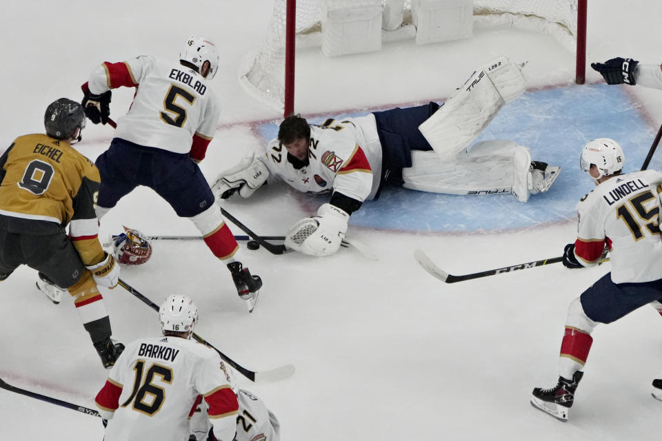 Florida Panthers goaltender Sergei Bobrovsky (72) attempts to cover the puck against the Vegas Golden Knights during the first period of an NHL hockey game Thursday, Jan. 12, 2023, in Las Vegas. (AP Photo/John Locher)