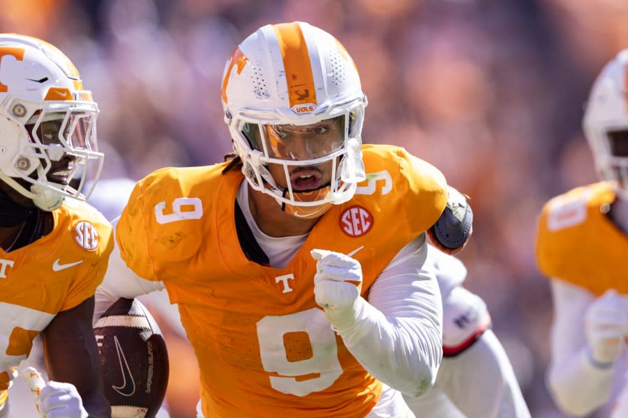 Tennessee defensive lineman Tyler Baron (9) returns a fumble for a touchdown during the first half of an NCAA college football game against UConn, Saturday, Nov. 4, 2023, in Knoxville, Tenn. (AP Photo/Wade Payne)