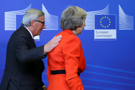 British Prime Minister Theresa May is welcomed by European Commission President Jean-Claude Juncker at the EC headquarters in Brussels, Belgium October 21, 2016. REUTERS/Yves Herman