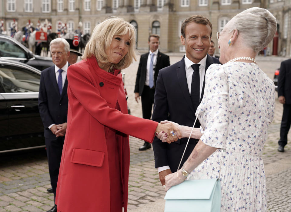 French first lady Brigitte Macron, left shakes hands with Denmark's Queen Margrethe as she and President Emannuel Macron arrive at Amalienborg Castle in Copenhagen Denmark, Tuesday Aug. 28, 2018. Macron is on a two-day visit, hoping to build the relationships he needs to push France’s agenda of a more closely united European Union. (Martin Sylvest/Ritzau Scanpix via AP)