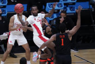 Houston guard DeJon Jarreau (3) passes over Oregon State forward Maurice Calloo (1) during the first half of an Elite 8 game in the NCAA men's college basketball tournament at Lucas Oil Stadium, Monday, March 29, 2021, in Indianapolis. (AP Photo/Darron Cummings)