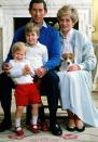 <p>Prince Charles, Prince of Wales and Diana, Princess of Wales at home in <a href="https://www.elledecor.com/life-culture/a9104379/upper-class-words/" rel="nofollow noopener" target="_blank" data-ylk="slk:Kensington Palace;elm:context_link;itc:0;sec:content-canvas" class="link ">Kensington Palace</a> with their sons Prince William and Prince Harry in December 1986.</p>