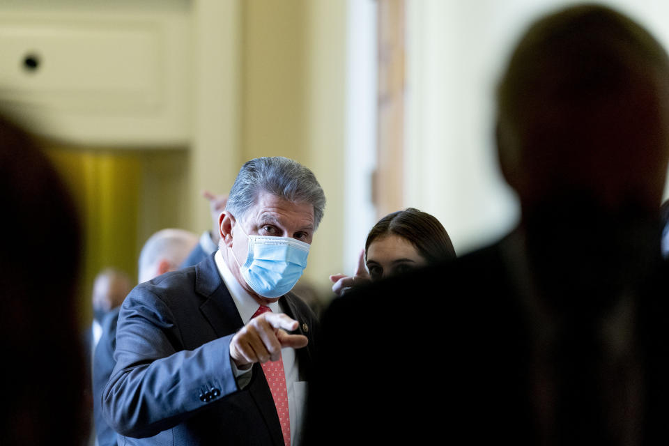 Sen. Joe Manchin speaks to an aide as he walks out of a Democratic policy luncheon in Washington, Tuesday, Sept. 14, 2021. (AP Photo/Andrew Harnik)