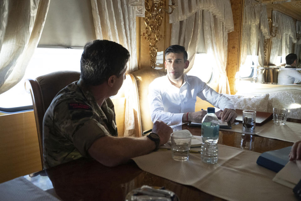 Britain's Prime Minister Rishi Sunak, right, speaks with Vice Chief of the Defence Staff Major General Gwyn Jenkins on a train travelling through Ukraine as he heads to meet with President Volodymyr Zelensky after announcing a major new package of £2.5 billion in military aid to the country over the coming year, near Kyiv, Ukraine, Friday Jan. 12, 2024. (Stefan Rousseau/Pool via AP)