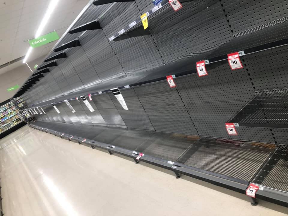 Woolworths shelves can be seen empty of toilet paper. 