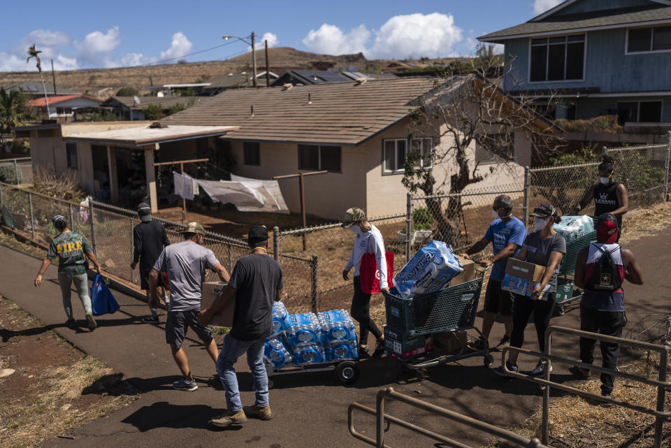 Volunteers make food and supply deliveries to elderly residents affected by a deadly wildfire in Lahaina, Hawaii, Saturday, Aug. 19, 2023. (AP Photo/Jae C. Hong)
