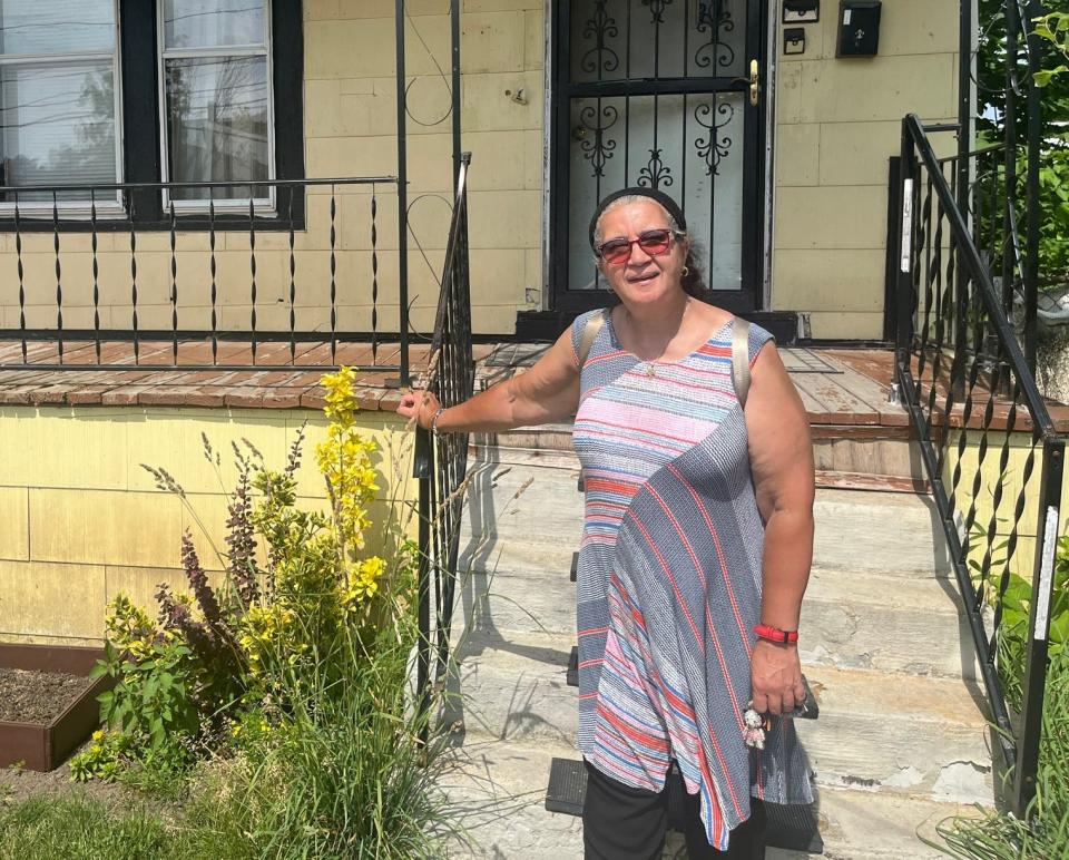 Activist Dennice Barr stands in front of her home in Buffalo's historic Fruit Belt neighborhood on the East Side, which has long lacked a walkable grocery store. Barr criticizes chains like Wegmans for not serving Black residents, and says she looks forward to a forthcoming community-owned store from African Heritage Food Co-op.