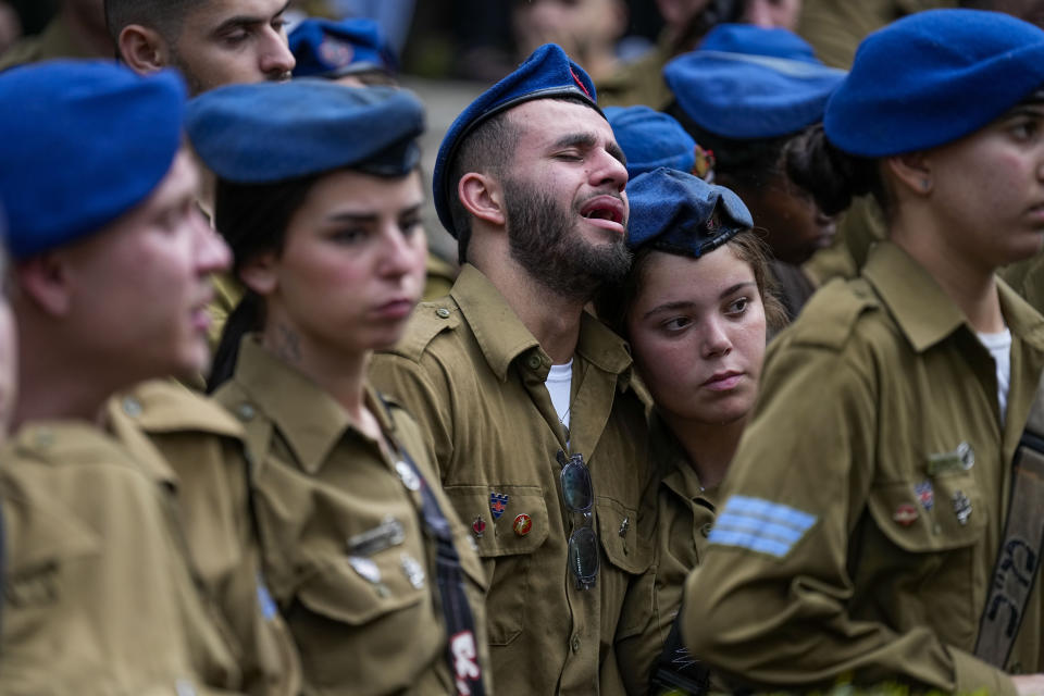 Israeli soldiers mourn during the funeral of Israeli soldier Corporal Avraham Fetena in Haifa, northern Israel, Friday, Nov. 17, 2023. Fetena, 20, was killed and six people were wounded in a shooting attack by three Palestinians at the checkpoint — all of whom were shot dead on the scene, Israel's rescue services said Thursday. (AP Photo/Ariel Schalit)