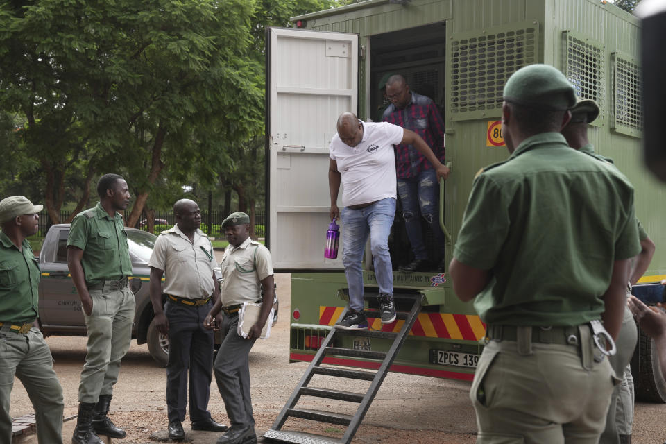 Zimbabwean opposition figure Job Sikhala disembarks from a prison truck upon his arrival at the magistrates courts in Harare, Wednesday, Jan, 24. 2024. A Zimbabwean court is expected to give judgment Wednesday on Sikhala who spent nearly two years in pretrial detention on political charges. (AP Photo/Tsvangirayi Mukwazhi)