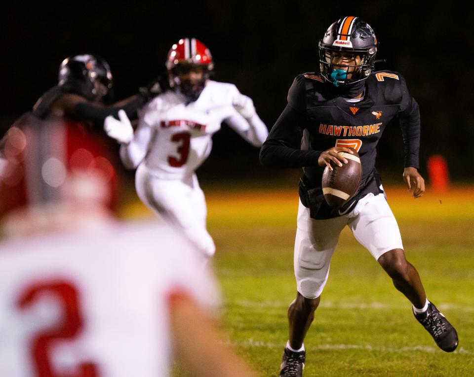 Hawthorne Hornets quarterback Cj Ingram (7) looks for an open receiver. The Hawthorne Hornets hosted the Blountstown Tigers at Hawthorne High School in Hawthorne, FL on Thursday, November 30, 2023 in the Class 1R State Semis Football. The Hornets defeated the Tigers 49-0 and advance to the State Championship game next Thursday in Tallahassee. [Doug Engle/Gainesville Sun]