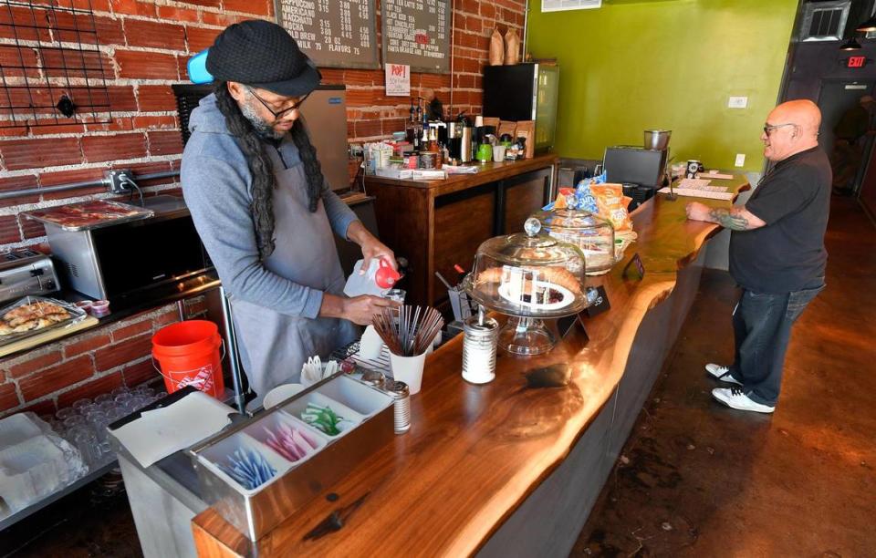 Brad Williams, left, serves a customer at The Borough.