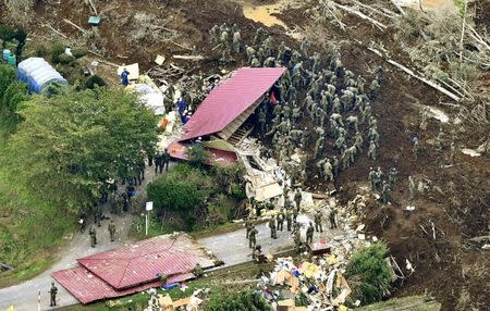 Members of the Japan Self-Defense Forces (JSDF) search for survivors from a house damaged by a landslide caused by an earthquake in Atsuma town, Hokkaido, northern Japan, in this photo taken by Kyodo September 7, 2018. Mandatory credit Kyodo/via REUTERS