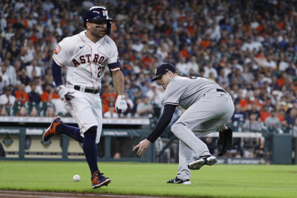New York Yankees starting pitcher Jordan Montgomery fields a bunt hit for a single by Houston Astros' Jose Altuve during the first inning in the first game of a baseball doubleheader Thursday, July 21, 2022, in Houston. (AP Photo/Kevin M. Cox)