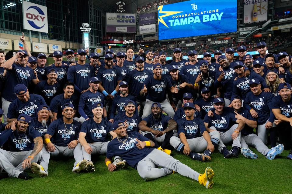 The Tampa Bay Rays pose for a team picture after a baseball game against the Houston Astros Friday, Sept. 30, 2022, in Houston. The Rays won 7-3 and clinched a postseason berth. (AP Photo/David J. Phillip)