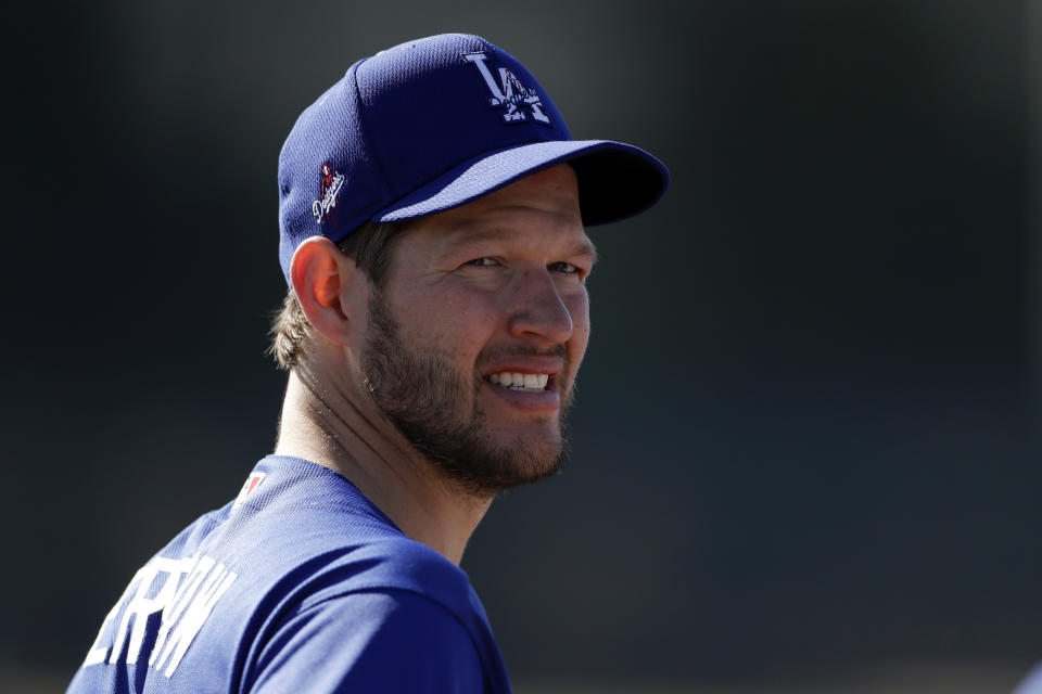 Los Angeles Dodgers pitcher Clayton Kershaw looks on during spring training baseball camp Friday, Feb. 14, 2020, in Phoenix. (AP Photo/Gregory Bull)