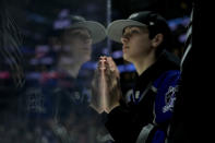 A fan rests his hands on the glass while waiting for an NHL hockey game between the Los Angeles Kings and the Tampa Bay Lightning, Saturday, March 23, 2024, in Los Angeles. (AP Photo/Jae C. Hong)